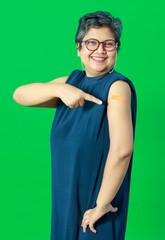 Adult senior Asian woman pointing and smile confident show shoulder with bandage plaster after...