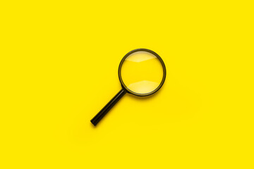 magnifying glass loupe search symbol on yellow background with copy space.