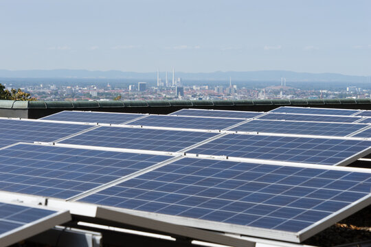 Solar panels on a roof, in the background view to the city of Karlsruhe, Germany