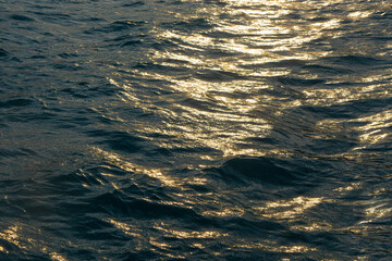  Dark Sea water surface  with golg glare  sunset .
