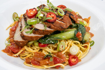 A delicious plate of spicy Chinese pork and noodles