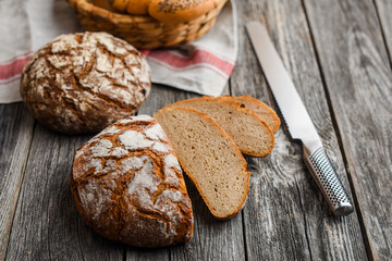 Homemade sourdough bread and buns on the wooden background