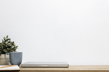 A mockup device on table on white wall.