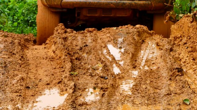 A close up shot of Four-wheel drive pickup truck stuck in the mud and trying to get out of the quagmire.