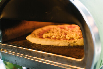 Pizza that is baking in the wood fired oven