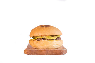 Juicy cheeseburger on wooden cutting board isolated on white background
