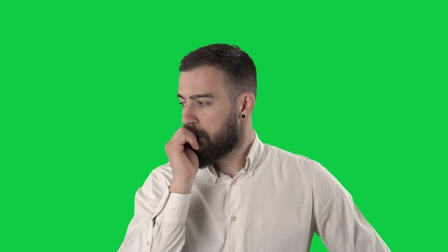 Nervous anxious young man bite nails in restless anticipation. Portrait isolated on green screen background. 
