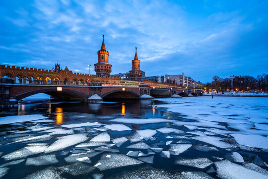 Oberbaum Bridge (Oberbaumbr&uuml;cke) and frozen Spree River at night, Berlin, Germany