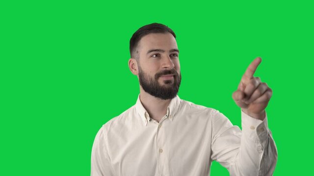 Business man using various touch screen gestures on invisible virtual reality screen. Portrait isolated on green screen background. 