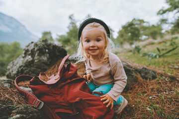 Child girl with backpack travel family vacations lifestyle 2 years old baby smiling hiking outdoor happy emotions