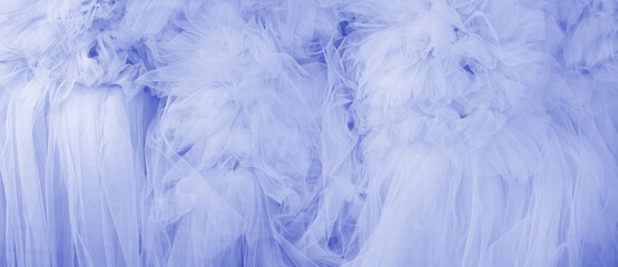 Beautiful folds of transparent blue fabric. Textile texture.