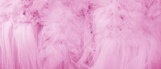 Beautiful folds of transparent pink fabric. Textile texture.