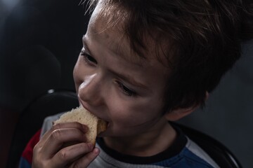 Dirty child eat bread face. donations kid