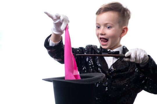 Magician kid illusionist boy in hat. suit trick isolated white background