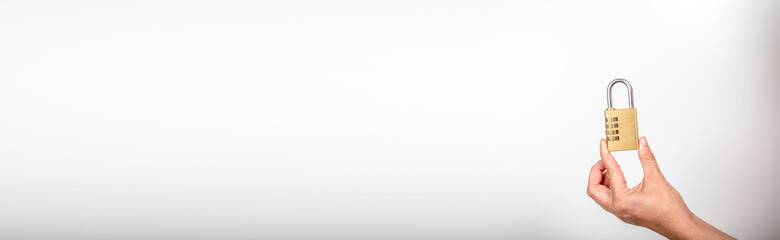 Padlock with a code in a woman's hand on a long horizontal banner