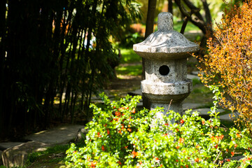 Beautiful landscape of bamboo forest and old stone lamp in the park walking path