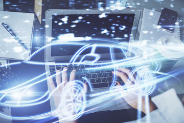 Double exposure of woman hands typing on computer and automobile theme drawing. High Tech concept.