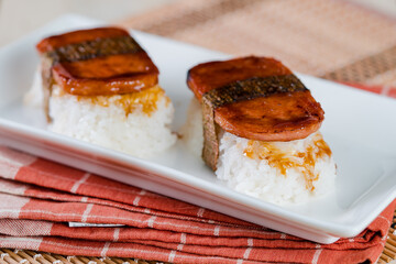 Spam musubi is a popular snack and lunch food in Japan that composed of spam on top of rice wrapped...