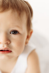 Close-up portrait of a beautiful baby girl on the white background indoor