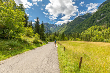 Fototapeta na wymiar Landscape photo of a woman hiking a trail in the Julian Alps, Triglav National Park, Slovenia.