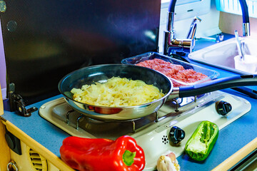 Caravan inside, cooking meal in kitchen area