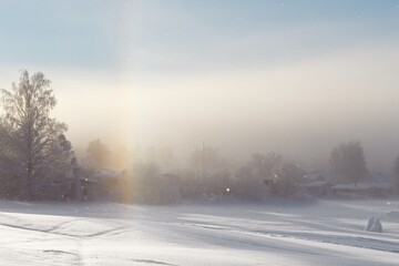 Fototapeta na wymiar The side sun and diamond dust phenomenon on a winter day in Östersund