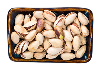 peeled and unpeeled Pistachio nuts in bowl cutout