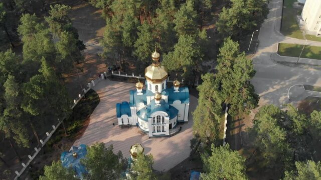 A drone flight of the Temple of St. Luke, Archbishop of Simferopol and Crimea, confessor in Sumy. Church on a hill, in the state forest reserve. Ukrainian Orthodox Church. Moscow Patriarchate.