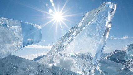 The bright winter sun shines through a transparent block of ice