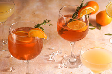 Orange christmas alcoholic beverage aperol spritz and lemonade with oranges, tangerines and...