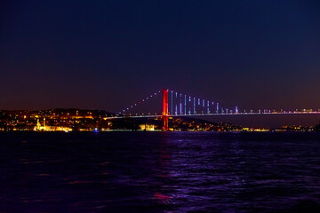 Fototapeta na wymiar Evening boat trip on the Bosphorus in Istanbul. Bosphorus Bridge, in the night lights
