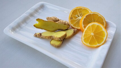 Lemon and ginger slices on a white plate