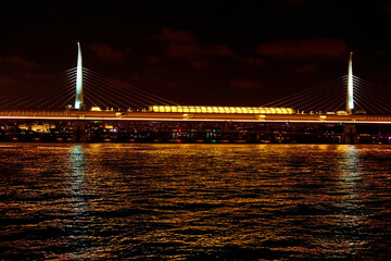 Naklejka premium Evening boat trip on the Bosphorus in Istanbul. Bosphorus Bridge, in the night lights