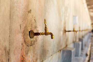 Taps with water for washing the feet for the entrance to the mosque
