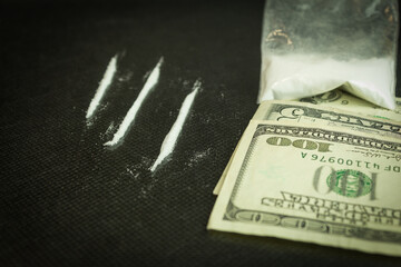 Drugs and dollars on a glass table