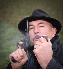 Man with gun  system Nagan smoking his pipe