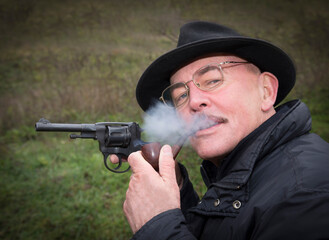 Man with gun  system Nagan smoking his pipe