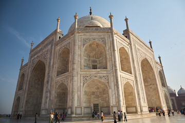 Fototapeta na wymiar Side view of the Taj Mahal. Frog perspective. Blue sky. Love carved in marble. A dream for any sculptor or artist. Day.