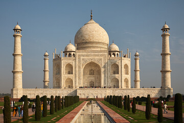 Fototapeta na wymiar Classic postcard view of the Taj Mahal in Agra/India. Day. Normal perspective. Blue Sky. Marvel. Love carved in marble.