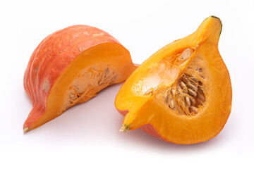 Pumpkin, cut into pieces, on a white background 