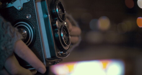 Woman with retro camera near entrance to subway