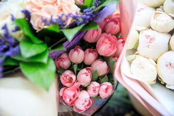 Bouquet of red tulips with rain drops between bouquets of hyacinths, hydrangeas