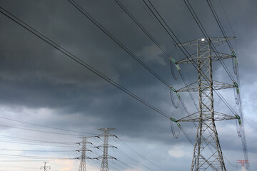 Several electrical transmission towers and high voltage wires with a stormy sky, Kuala Lumpur, Malaysia