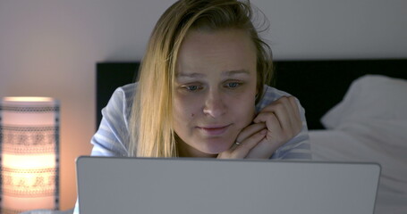 Woman spending leisure time with laptop and movie