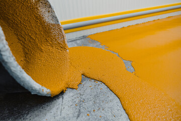 Worker applying epoxy and polyurethane flooring system