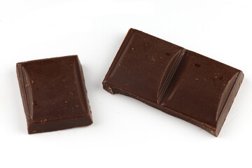 Pieces of dark chocolate on a white background isolate