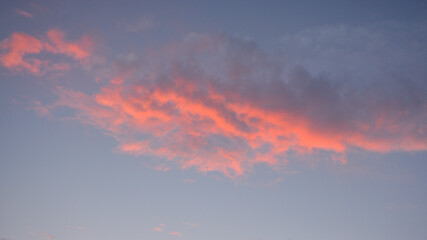 Naklejka na ściany i meble Pink cloud in the evening sunset with purple lining