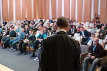 Male presenter speaks to audiences at seminar