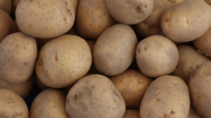 Unpeeled raw potatoes background at the vegetable market in Turkey