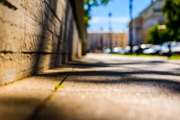 Summer in the city, the empty street. Close up view from the wall